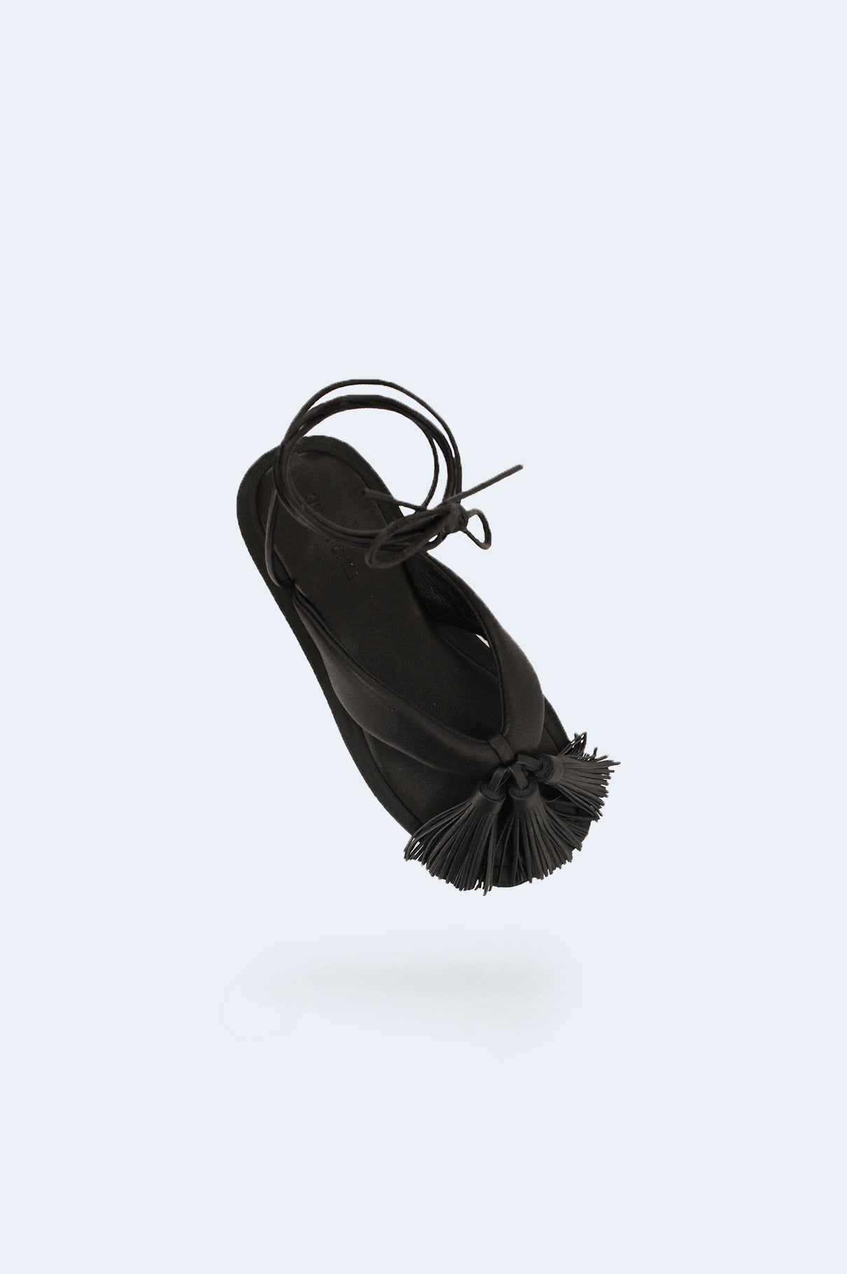 Black leather sandal with tassels